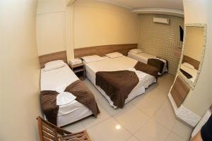 a room with two beds in a room at Aeroporto Plaza Hotel in Campo Grande