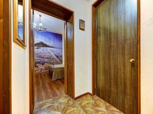 a hallway with a wooden door and a table at Cosy apartment for couple in Šibenik
