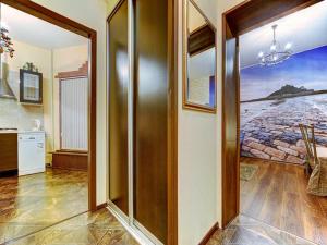 a hallway with a door to a kitchen with a painting at Cosy apartment for couple in Šibenik