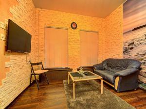 a living room with a leather couch and a table at Cosy apartment for couple in Šibenik