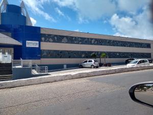 a building with two cars parked in front of it at Terrazzo PontaNegra flat Flat Vista Mar Apto 201 in Natal