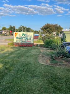 a sign for a home town studios resort at HomeTowne Studios by Red Roof Louisville in Louisville