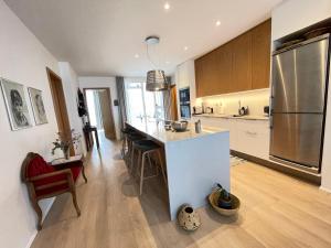a kitchen with a white counter and a refrigerator at Naustavör 30 in Reykjavík