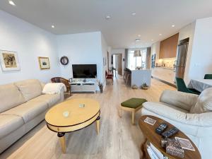 a living room with a couch and a table at Naustavör 30 in Reykjavík
