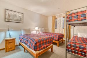 a bedroom with two beds and a bunk bed at Little Trail Lodge - Unit A in Government Camp