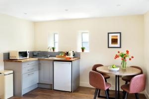 a small kitchen with a table and chairs at Shoulder of Mutton Inn in Harrogate