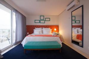 Cama ou camas em um quarto em Doral Guarujá