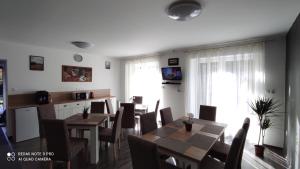 a dining room with a table and chairs at Lővér Vendégház Sopron in Sopron
