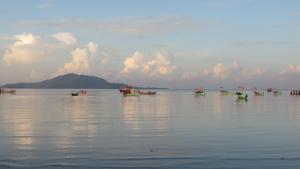 a group of boats sitting in the water at Kep Guesthouse in Kep