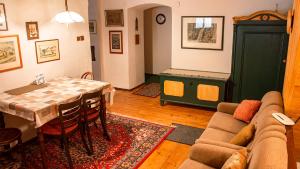 a living room with a table and a couch at Penzion 1670 in Nové Hrady