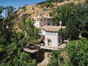 a house on the side of a mountain at El Molino in Cazorla