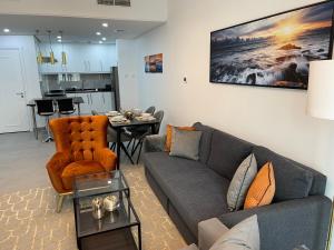 a living room with a couch and a table at Birchfort - Newly renovated unique 1 bedroom apartment in Dubai