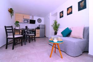 a living room with a couch and a table at La Cosy House in Evry-Courcouronnes