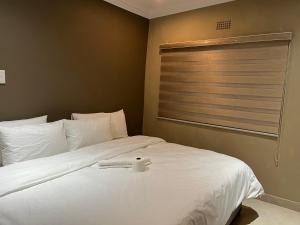 Maponya Guest House tesisinde bir odada yatak veya yataklar