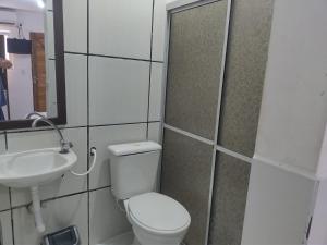 a bathroom with a toilet and a sink at Pousada Nascer do Sol in João Pessoa