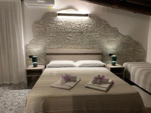 a bedroom with two beds with towels on them at Villa Anna GuestHouse in Brindisi