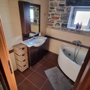 a bathroom with a sink and a bath tub at Villa Vigneto 