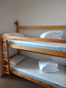 two bunk beds with white pillows on them at Studio avec vue panoramique sur la montagne in Font-Romeu-Odeillo-Via