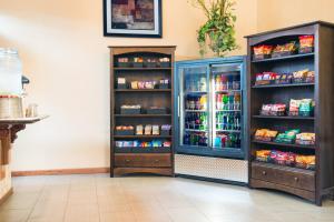 a store with a refrigerator with food and drinks at Travelodge by Wyndham Enid in Enid