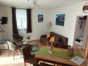 a living room with a couch and a table at Appartement Naturnah in Mieders