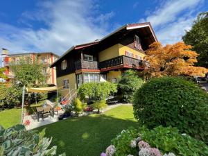 a large house with a lawn in front of it at LANDHAUS luise in Bad Reichenhall