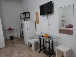 a small room with a table and a bed at Pousada Solar Encanto do Marajó in Soure