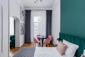 a bedroom with a bed and a table and chairs at Wawel Boutique Residence - Krakow Old Town in Kraków