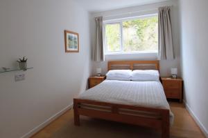 a bedroom with a bed and a window at Porthpean Apartment in Charlestown