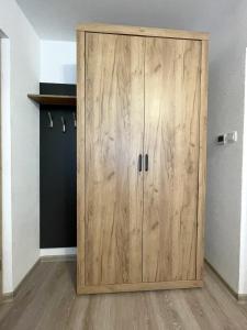 a wooden cabinet in the corner of a room at Apartments and rooms pri Bašlju in Cerkno