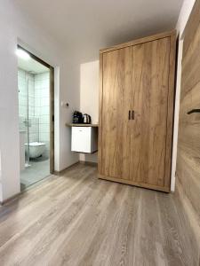 a bathroom with a large wooden cabinet in a room at Apartments and rooms pri Bašlju in Cerkno