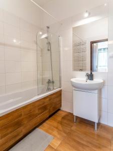 a bathroom with a sink and a shower and a tub at FIRST -- Green Żoliborz apartment 3 in Warsaw