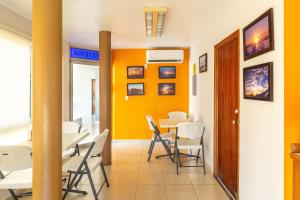 a dining room with yellow walls and tables and chairs at Hotel Mazatlan in Mazatlán