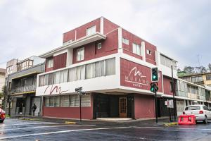 un edificio rojo y blanco en la esquina de una calle en Hotel Murano, en Concepción