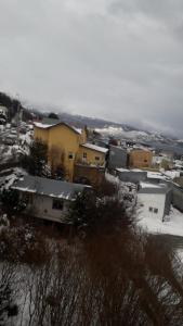 a group of buildings in a city with snow at MyR alojamiento in Ushuaia