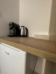 a counter top with a coffee pot and tea on it at Apartments and rooms pri Bašlju in Cerkno