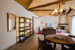 a living room with a table and a dining room at Piattelli Wine Resort Hotel Cafayate in Cafayate