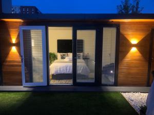 a bedroom with sliding glass doors and a bed at MeeZee Pearl Double Bed Lodge With Free Parking in Manchester