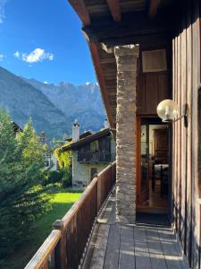 a balcony of a house with a view of mountains at Chalet Blanc "Coeur Sapin" in Courmayeur