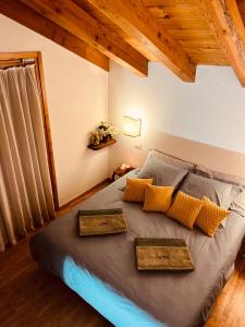 a bedroom with a bed with two tr tables on it at Chalet Blanc "Coeur Sapin" in Courmayeur