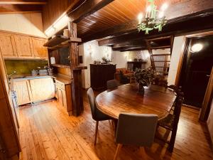 a kitchen and dining room with a wooden table at Chalet Blanc "Coeur Sapin" in Courmayeur