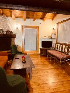 a living room with a table and a couch at Chalet Blanc "Coeur Sapin" in Courmayeur