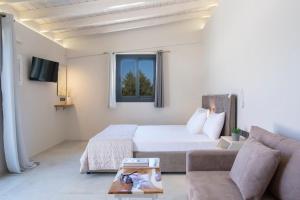 a bedroom with a bed and a couch at Lefkolia Retreat in Sivota