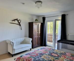 a bedroom with a couch and a chair and a window at Lovely spacious Apartment-80m2-OLD STYLE-tourist area in Rauth