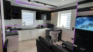 una cocina con sofá y TV. en #5 TGHA Luxury One Bedroom Apartment in Athlone, en Athlone