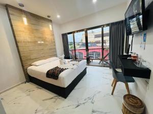 a bedroom with a bed and a desk and a television at Hotel Ko'ox Wenne in Tulum +68 photos