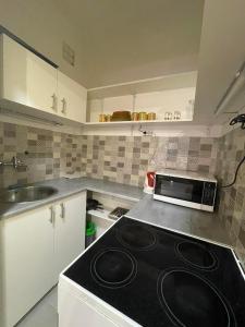 a kitchen with a black stove top oven in it at Home in the Heart in Budapest