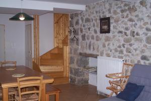 a kitchen and dining room with a table and chairs at Domaine de Salomony in Marcols-les-Eaux