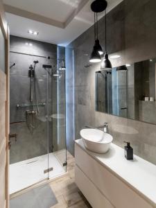 a bathroom with a sink and a glass shower at FIRST -- Green Żoliborz Apartment 5 in Warsaw