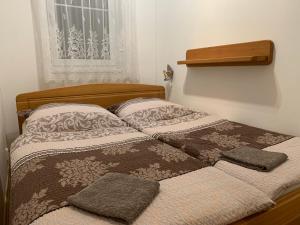 a bed with two pillows on it in a bedroom at Apartmán Horní Mísečky in Vítkovice