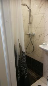 a bathroom with a shower with umbrellas in it at Studio nearby the Kalnciema quarter in Rīga